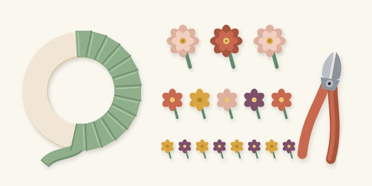 Foam ring half wrapped in ribbon beside flower heads sorted into large, medium and small