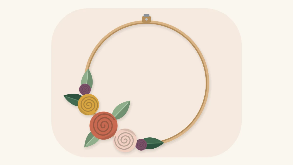 Wooden hoop wreath with rolled felt roses and felt leaves clustered on the lower left