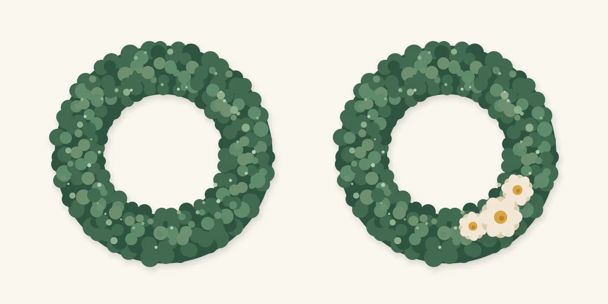 A plain moss wreath beside one with a small accent of three flowers