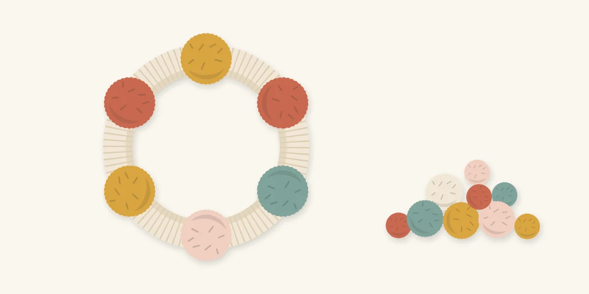Ring with six large pom-poms placed first and smaller pom-poms waiting beside it